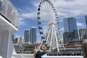 Seattle Great Wheel: an enormous ferris wheel as seen from Argosy Cruise, with Seattle sky scrapers behind it